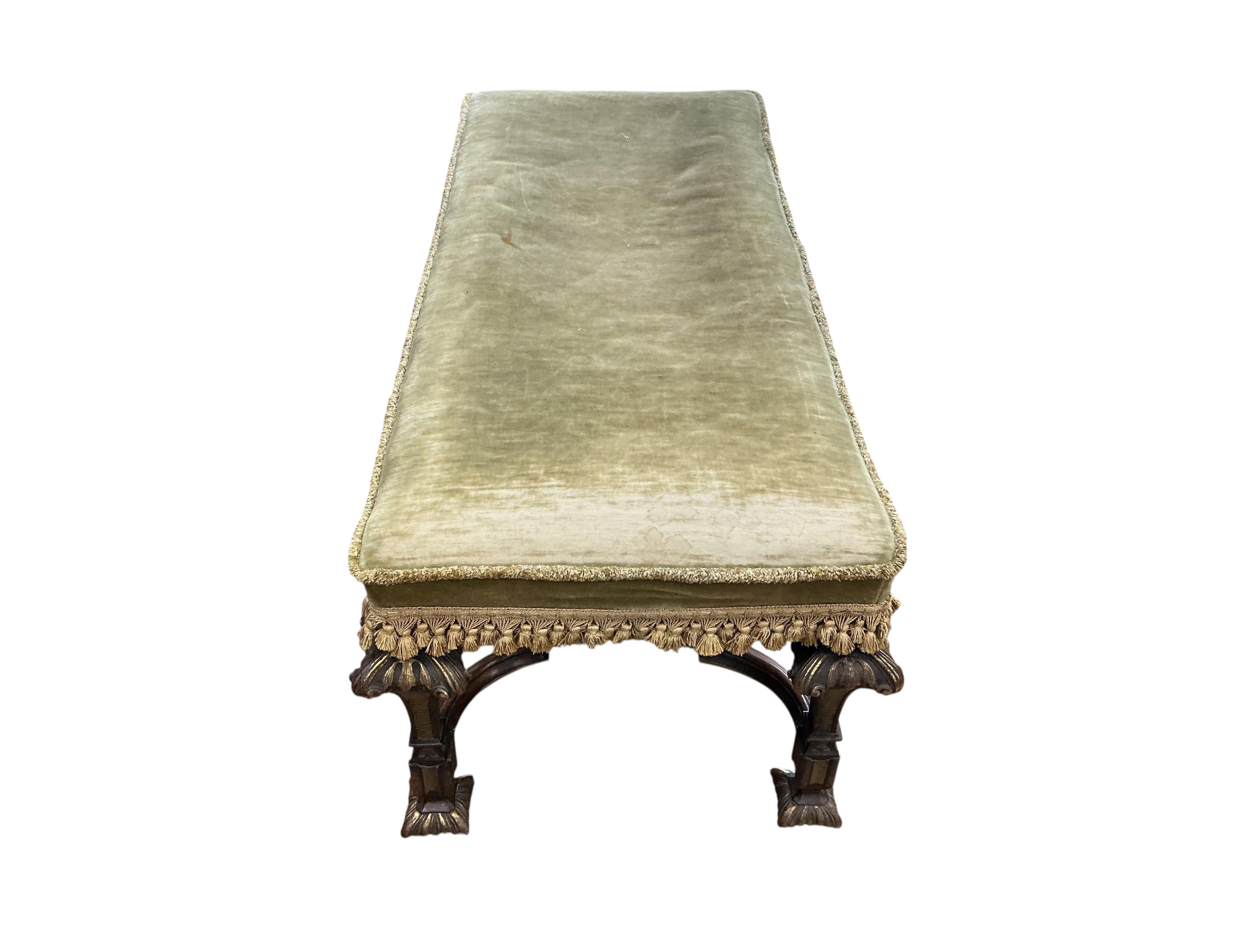 An 18th century style upholstered parcel gilt walnut stool, width 110cm, depth 48cm, height 44cm